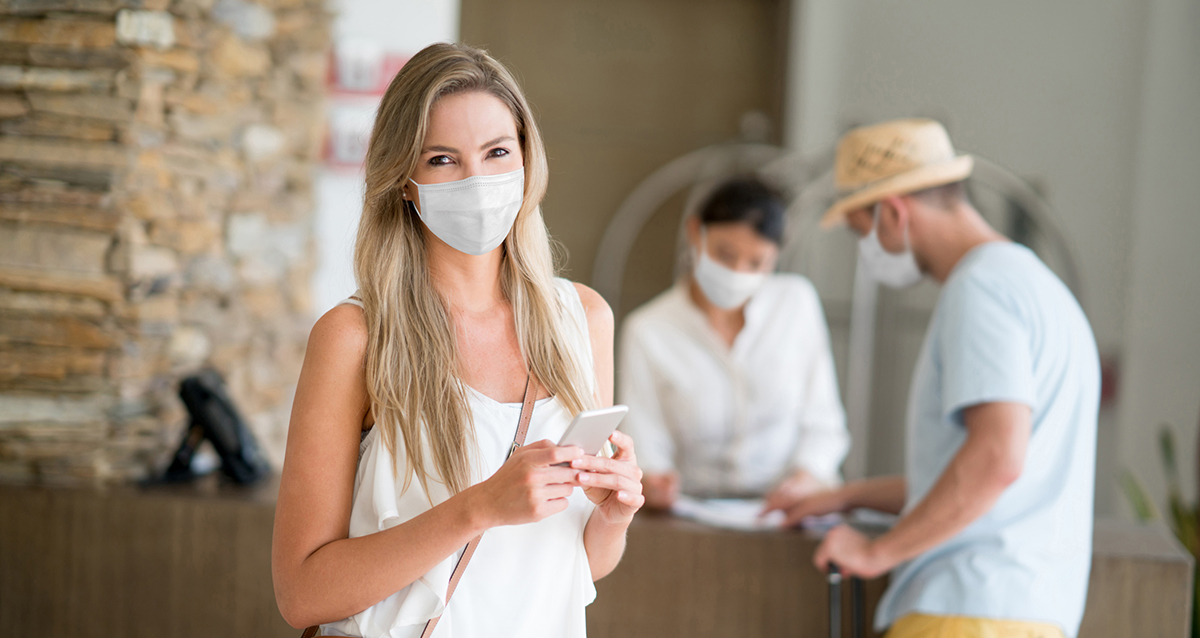 woman traveling at hotel with smart device